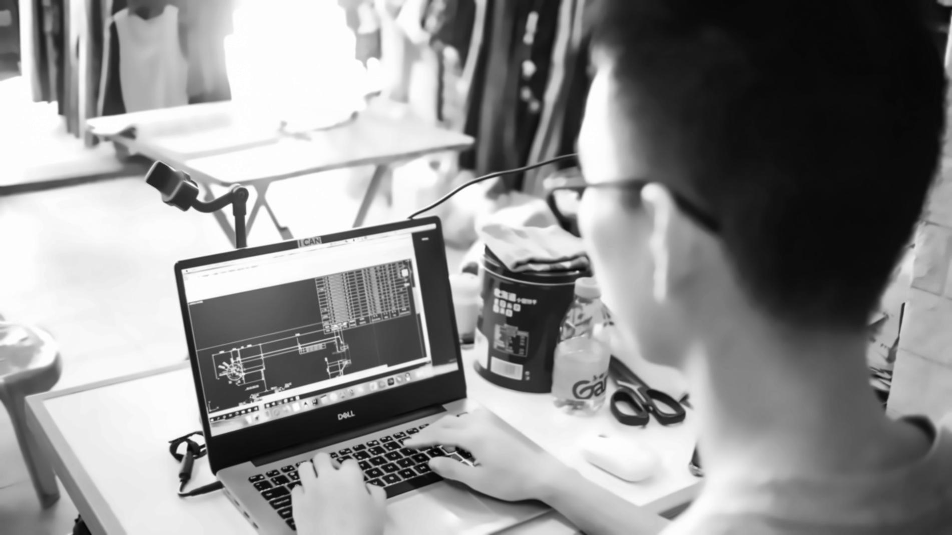 Focused individual analyzing financial data on laptop